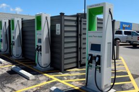 Electric vehicle charging stations are shown in the parking lot