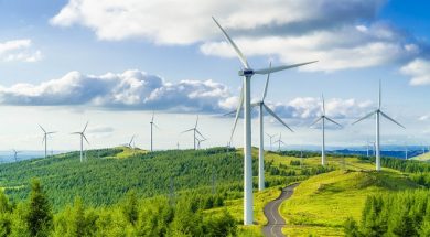 Wind turbines in fields on green hills