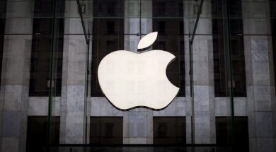 FILE PHOTO: An Apple logo hangs above the entrance to the Apple store on 5th Avenue in the Manhattan borough of New York City