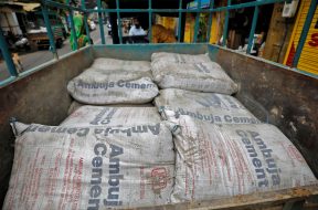 A view shows Ambuja Cement bags, to be carried to a construction site, in a load carrier in Ahmedabad
